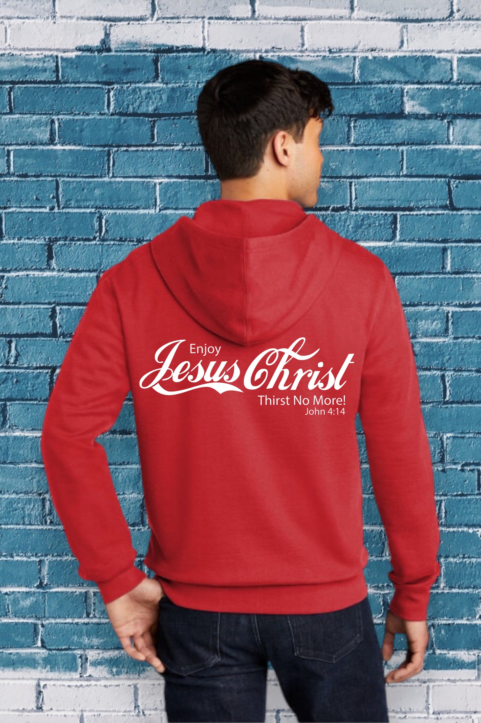 Person wearing a red hoodie with text against a blue brick wall