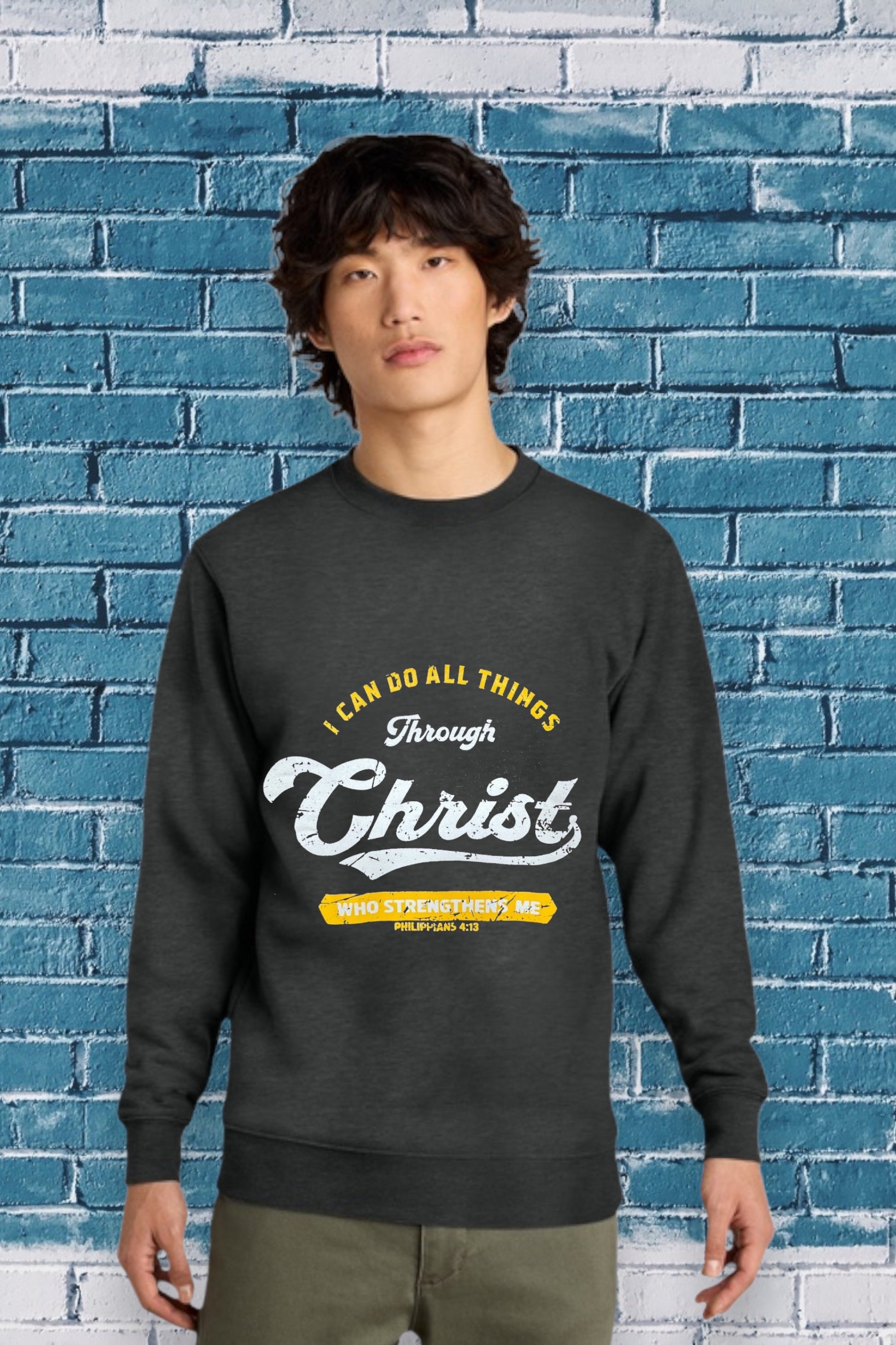 Charcoal sweatshirt with the Bible verse “I CAN DO ALL THINGS Through Christ WHO STRENGTHENS ME PHILIPPIANS 4:13” printed in yellow and white, featuring “Christ” in large cursive font.
