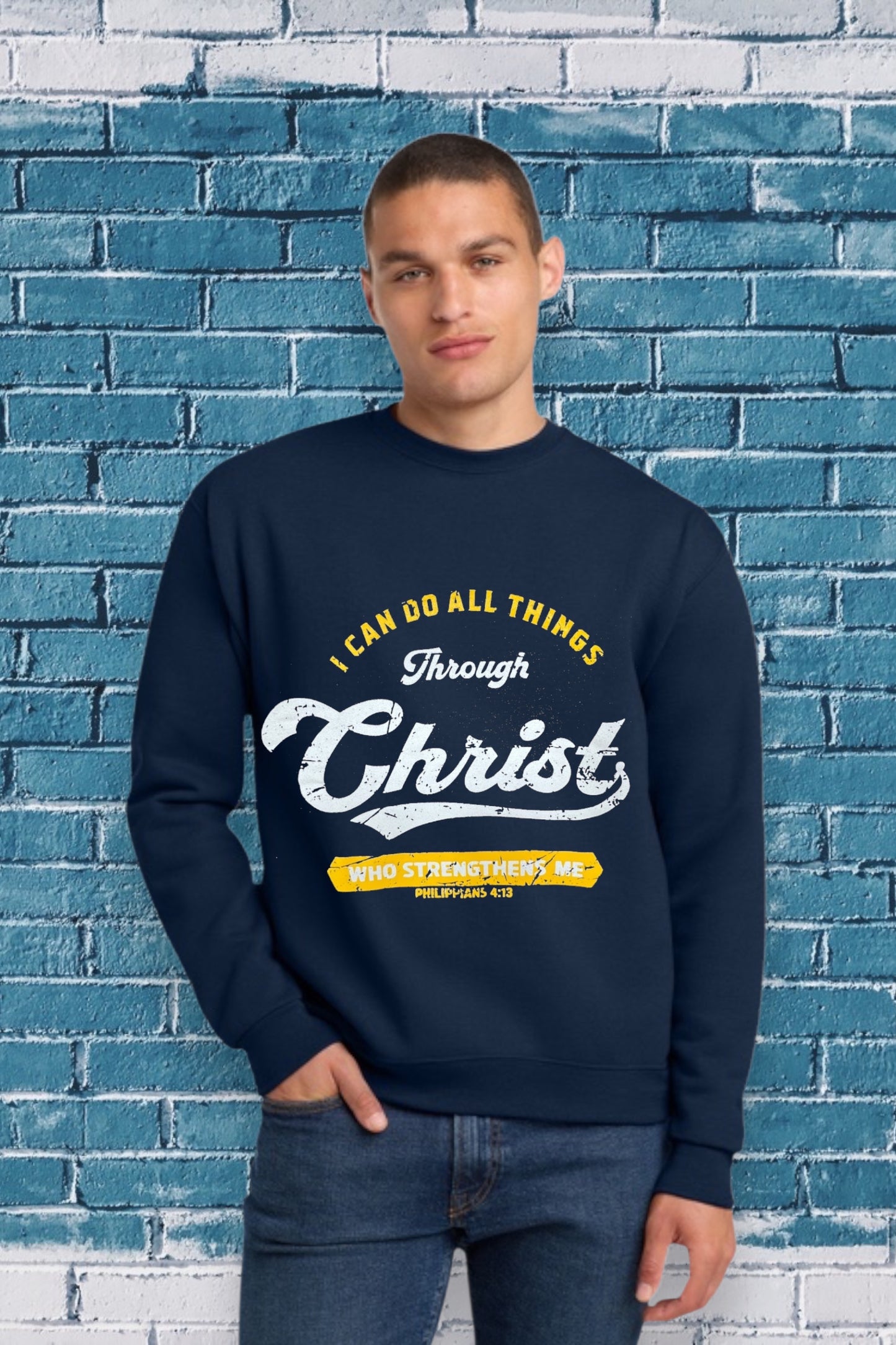 Navy blue sweatshirt with the Bible verse “I CAN DO ALL THINGS Through Christ WHO STRENGTHENS ME PHILIPPIANS 4:13” printed in yellow and white, featuring “Christ” in large cursive font.
